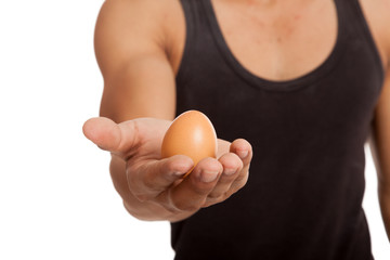 Egg in muscular Asian man's hand