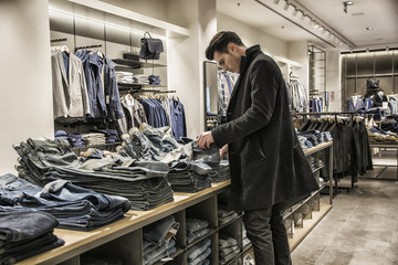 Young man choosing shirt