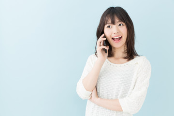 Fototapeta premium attractive asian woman on blue background