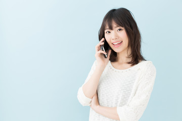 Fototapeta premium attractive asian woman on blue background