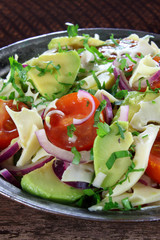 Salad with avocado, cheese, tomato and red onion