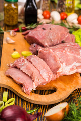 Chunks of meat sliced on cutting board
