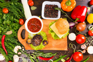 Hamburger Surrounded by Fresh Veggies and Toppings