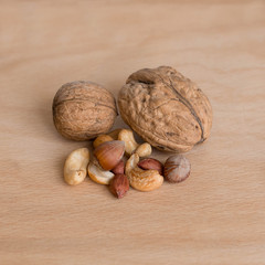 Mixed nuts at the wooden background