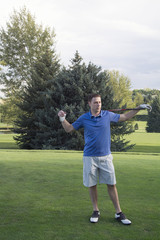 Male Golfer smiles as he relaxes at a game of golf