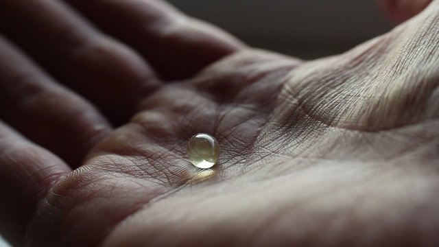 Pills drugs tablets in hands macro