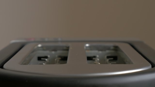 Toased bread popping up   from  toaster machine close-up 4K 2160p UHD footage - Making toast in toaster with two bread slices 4K 3840X2160 UHD video