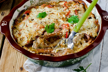 Carp baked with sour cream, pepper, bacon and onions
