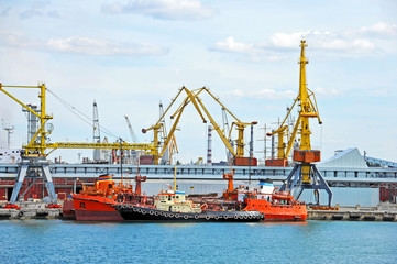 Bunker ship and tugboat under port crane