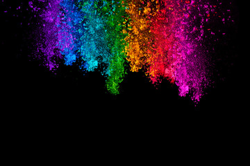 Fototapeta premium Falling colored powder isolated on black background