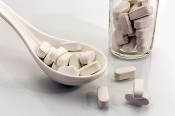 Spoon white with some pills, concept of health