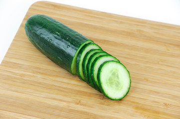 sliced cucumber on wooden board
