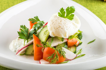 Fresh mixed vegetables salad on white plate
