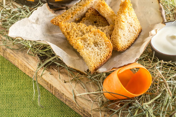 Top view of Healthy homemade soup in the jar and sliced bread on wooden board