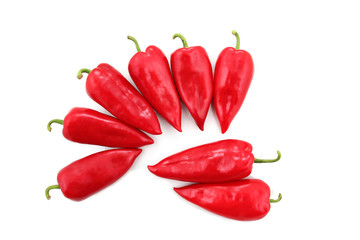 eight bright red sweet peppers on a white background