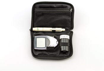 blood glucose meter, the blood sugar value is measured  a finger on white background