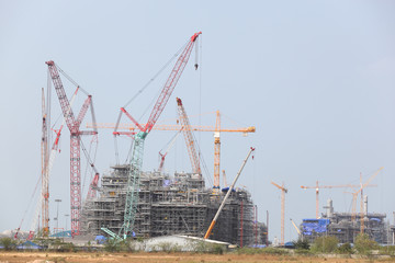 Chemical plant under construction with big crane