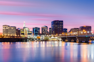 Hartford skyline and Founders Bridge under a purple twilight. Hartford is the capital of Connecticut.