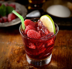 raspberries with sugar on wooden background