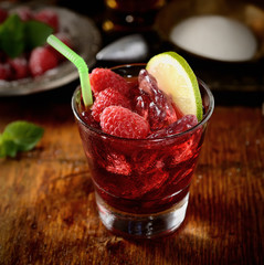 raspberries with sugar on wooden background