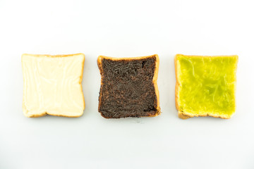 3 principle flavoured of bread : milk flavored cream spread bread slices and Sliced chocolate bread and Sliced thai custart bread isolate on white - copy space
