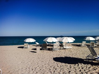 Deck chairs and umbrellas on the beach - vacations