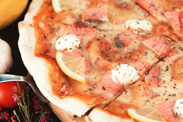 italian pizza with salmon, lemon and cheese