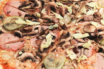 Pizza with ham, mushrooms and vegetables close up