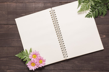 Pink flowers are on a notebook space for your text