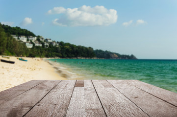 Fototapeta premium Wood floor top on blurred blue sea and white sand beach with som