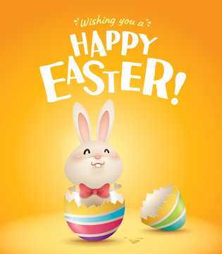Happy Easter! Easter bunny inside a cracked easter egg in plain background.