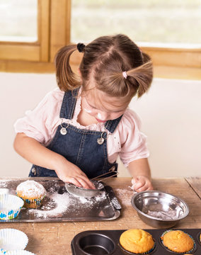 Little Girl Baking Cupcakes