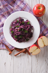 braised red cabbage with ingredients on the table. vertical top view
