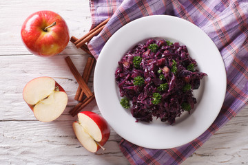 braised red cabbage with apples and cinnamon close-up. horizontal top view
