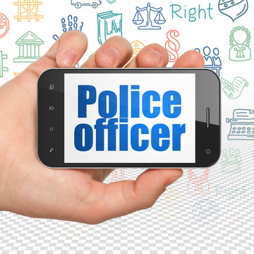 Law concept: Hand Holding Smartphone with Police Officer on display