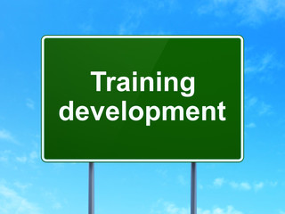 Education concept: Training Development on road sign background