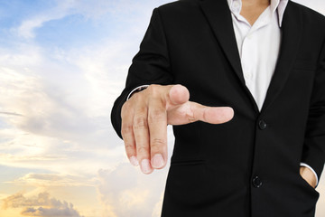Businessman pointing finger to screen, sky background
