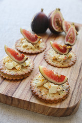 Cracker canapes with fresh fig and cream cheese, selective focus