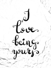 Typographic hand lettering poster on crumpled white paper. I love being yours