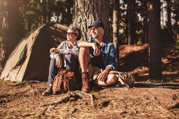 Mature couple relaxing at their campsite