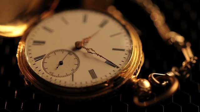 Stopped antique clock with chain