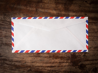 Air mail letter on wood background.