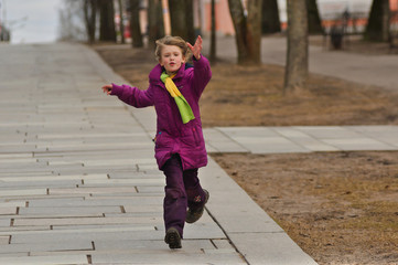 Young girl running the street - 104263015
