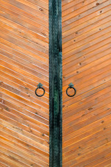 vertical shot Vintage wooden door with the ring close-up
