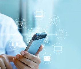 Man using mobile payment, holding circle global and icon custome