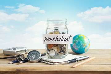 Money savings in a glass jar on blue sky background, Travel concept