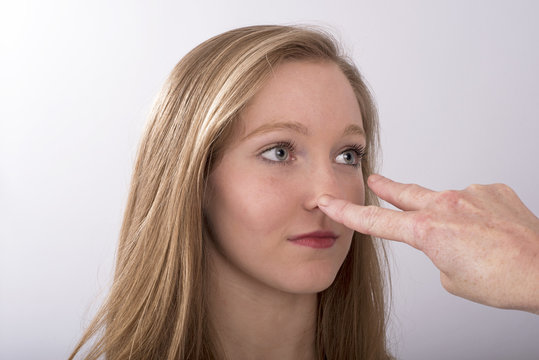 A two fingure gesture towards a young woman's eyes