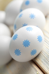 White Easter eggs on wooden planks