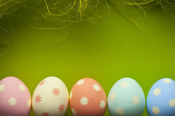 Colored Easter eggs and green background
