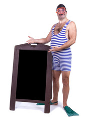 Man in swimsuit standing beside menu